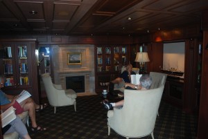 A rainy sea day can be the perfect time to enjoy a book by the "fire" in the library aboard Oceania's Marina.©Jean Janssen