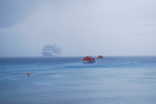 We are on Rangiroa in the third archipelago we are visiting in French Polynesia, the Tuamotu Islands.  I took this picture of the ship once we reached the shore.  It is another cloudy and rainy day.  In the foreground you see one of our tenders coming in and another headed back to the ship. ©Jean Janssen