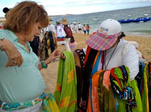 Margaret does a little bargaining on the beach and comes away with a colorful sarong.©Jean Janssen