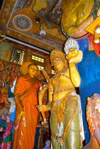 Three story Budda statutes.  Note man head to realize size.  At the Gangaramaya Temple, Colombo, Sri Lanka. ©Jean Janssen