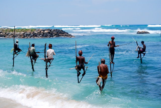 Stilt fisherman in the Indian Ocean at Galle, Sri Lanka. ©Jean Janssen