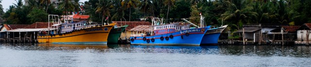 Named fishing boats at Kochi, India.  Note one is St. Michael.  The other has a picture of Jesus.  Names are reflective of the owner's religion. ©Jean Janssen