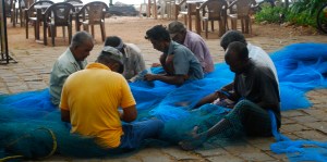 Repairing fishing nets.  Fort Kochi, India. ©Jean Janssen