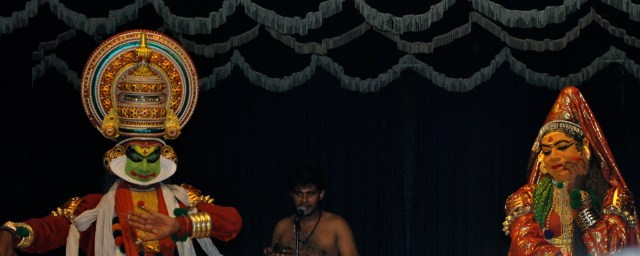 Kathakali performance, traditional Buddhist ritual, Kochi, India.  The chanter appears in the middle of the two "actors". ©Jean Janssen