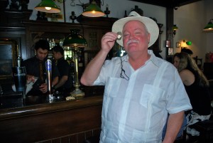 Boris at the Raffles Long Bar, monocle and all.  Had to get his Singapore Sling, invented at the Long Bar at the Raffles Hotel. ©Jean Janssen