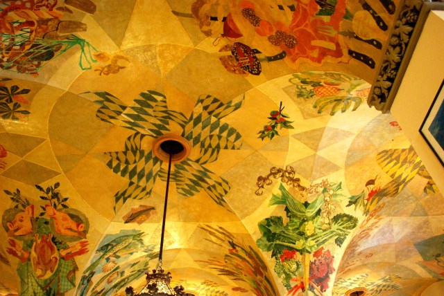 The Hofbrauhaus is perhaps the most famous beer garden in Munich.  It upper hall was a popular meeting and rally location for the Nazis.  Although rebuilt, the upper floor was damaged by bombs during WWII.  The lower hall was undamaged.  Its beautiful painted ceiling features a child's pinwheel using the color of the Bavarian flag.  Formerly, the pinwheel was a swastika.  The ceiling is protected for it historical significance.  Because it can not be repainted, artists cleverly "stored" the swastika to look like a pinwheel.  If yo look closely, you can see where the paint is darker and the original design exists. ©Jean Janssen