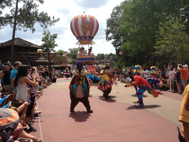 Chip, Dale, and Goofy lead in Mickey and Minnie as they arrive by balloon in the Festival of Magic Parade at the Magic Kingdom, WDW. ©Jean Janssen