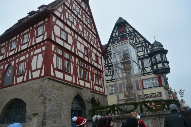 Georgsbrunnen, St. George's Fountain and the half-timbered Jagstheimer House, Rothenburg, Germany.  The fountain is enclosed at this time of year due to weather. ©Jean Janssen
