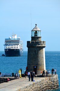 Lighthouse off St. Peter’s Port, Guernsey, Channel Islands with our ship the Azamara Quest in the background. @Jean Janssen