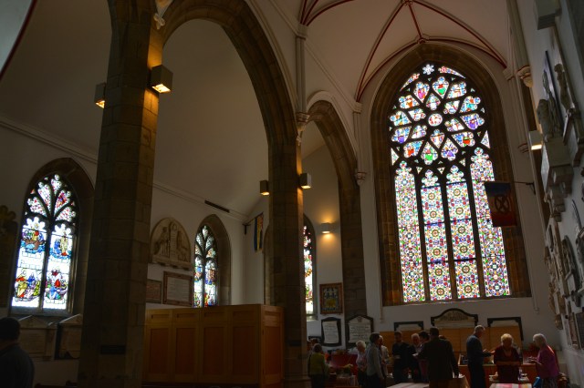 St. Peter’s Port Church. Note the beautiful stain glass and the parishioners enjoying refreshments after services right in the church @Jean Janssen