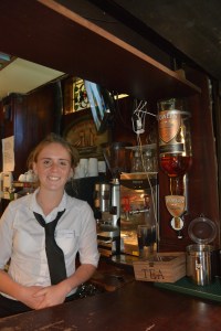 Our friendly barmaid Blaithin at the Abbey Tavern in Howth Ireland gave us a turn behind the bar and posed for us next to the large bottle of Powers Irish Whiskey used when making the Irish coffees. Blaithin grew up nearby.  ©Jean Janssen