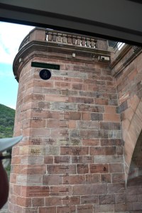 Boris checks out the markings on the bridge tower showing flooding levels and dates. Heidelberg, Germany ©Jean Janssen
