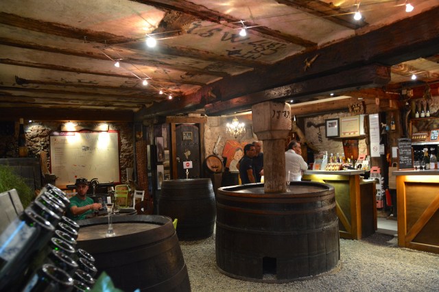Cellar wine tasting room in Riquewihr, France. Note the year carved into the post, 1579. ©Jean Janssen
